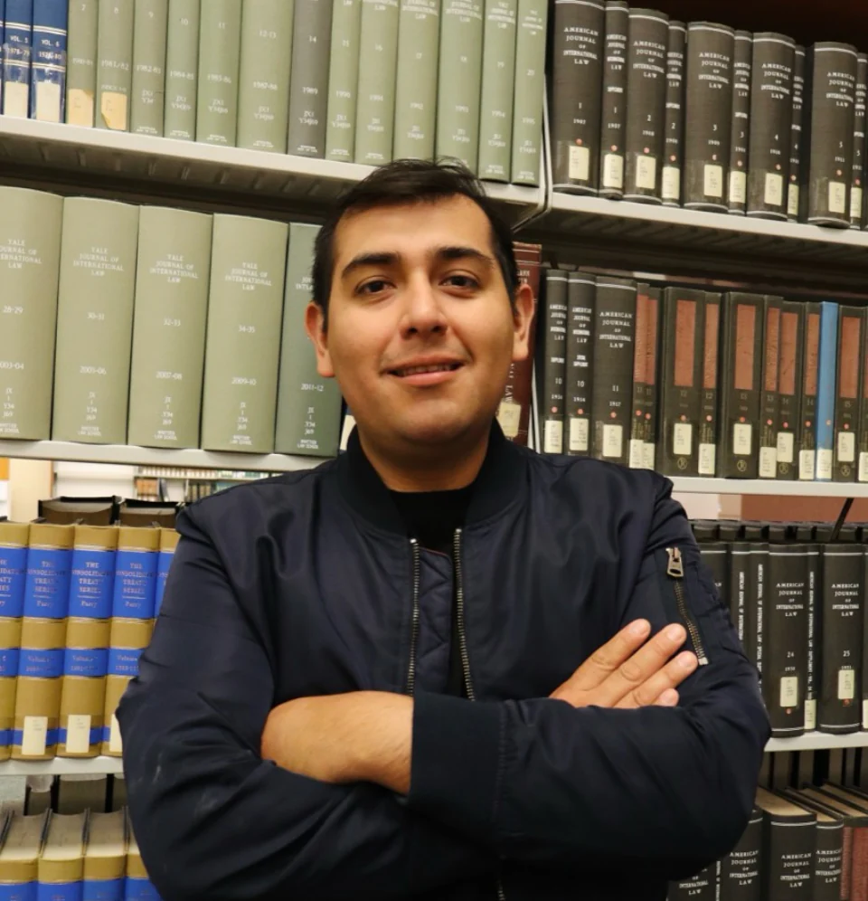 Portrait of Caleb Zhu in a library